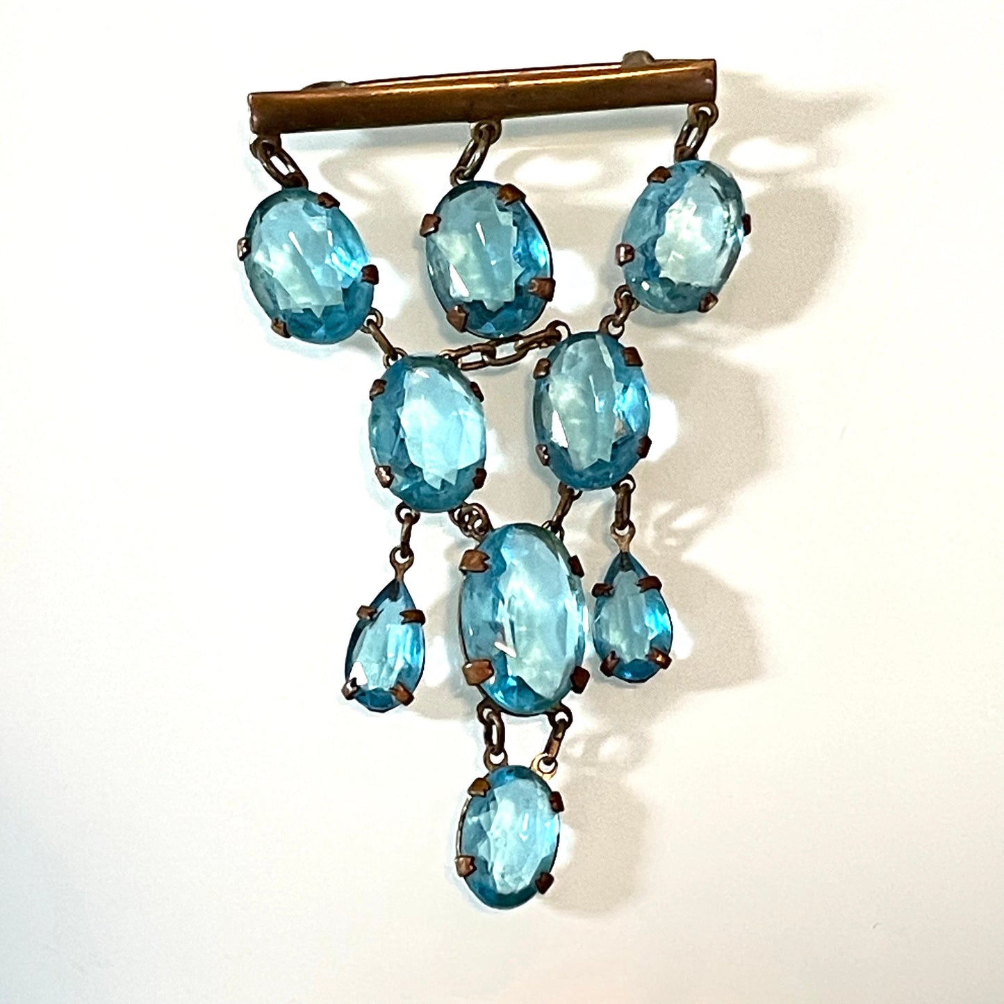 Vintage Art Deco aqua blue paste festoon dangle brooch with bezel set, open backed aquamarine coloured crystals set in antique gold tone