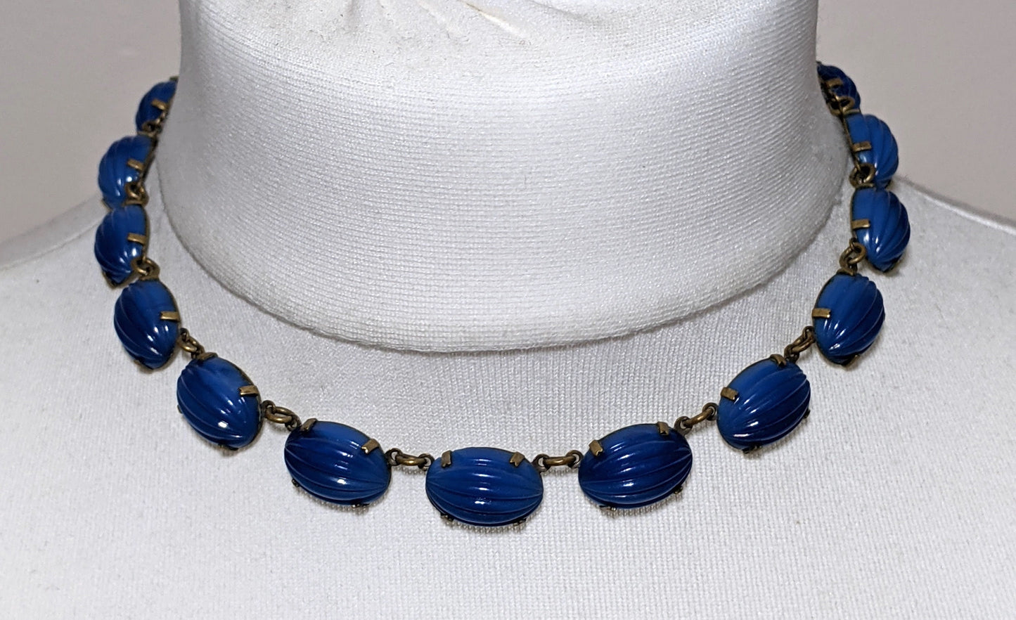 Vintage Art Deco bezel set royal blue moulded glass cabochon riviere necklace, open-backed settings in pretty engraved gold tone, 1920s-30s