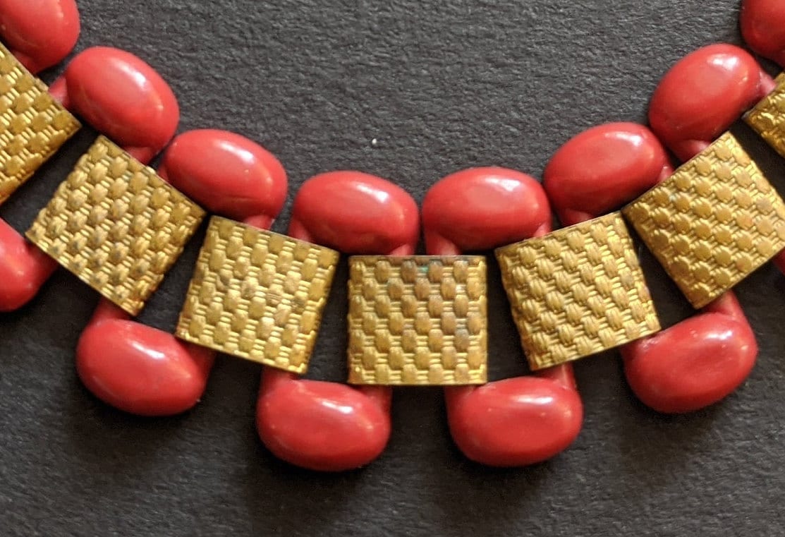 Vintage Art Deco red early plastic and tank track machine age gold tone repousse panel bracelet