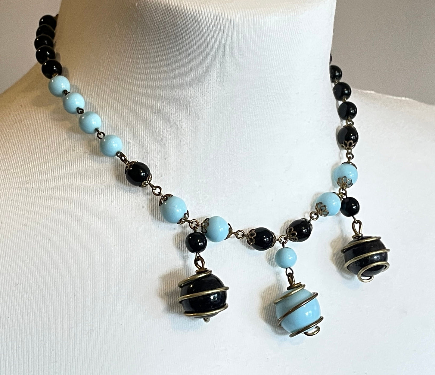 Vintage black and pale blue glass berry beaded charm necklace, gold tone wire spiral cages and filigree bead caps