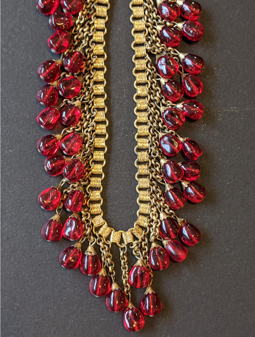 Vintage early Miriam Haskell ruby red poured glass beaded Egyptian revival fringe necklace with gold tone book chain - in box