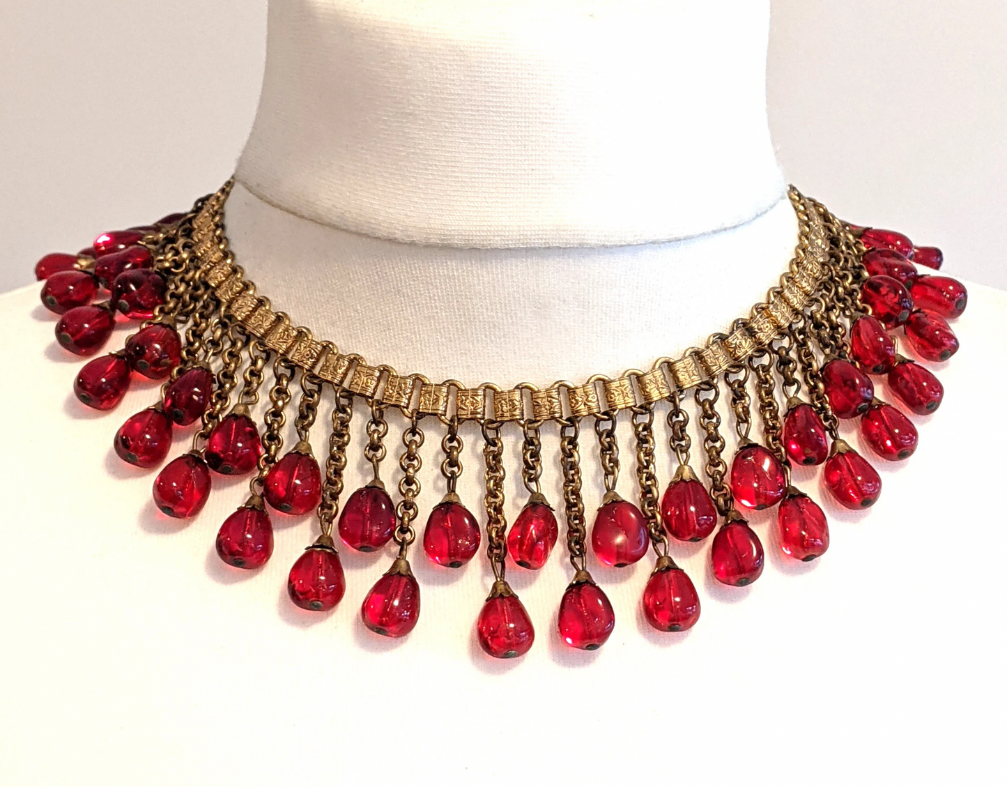 Vintage early Miriam Haskell ruby red poured glass beaded Egyptian revival fringe necklace with gold tone book chain - in box