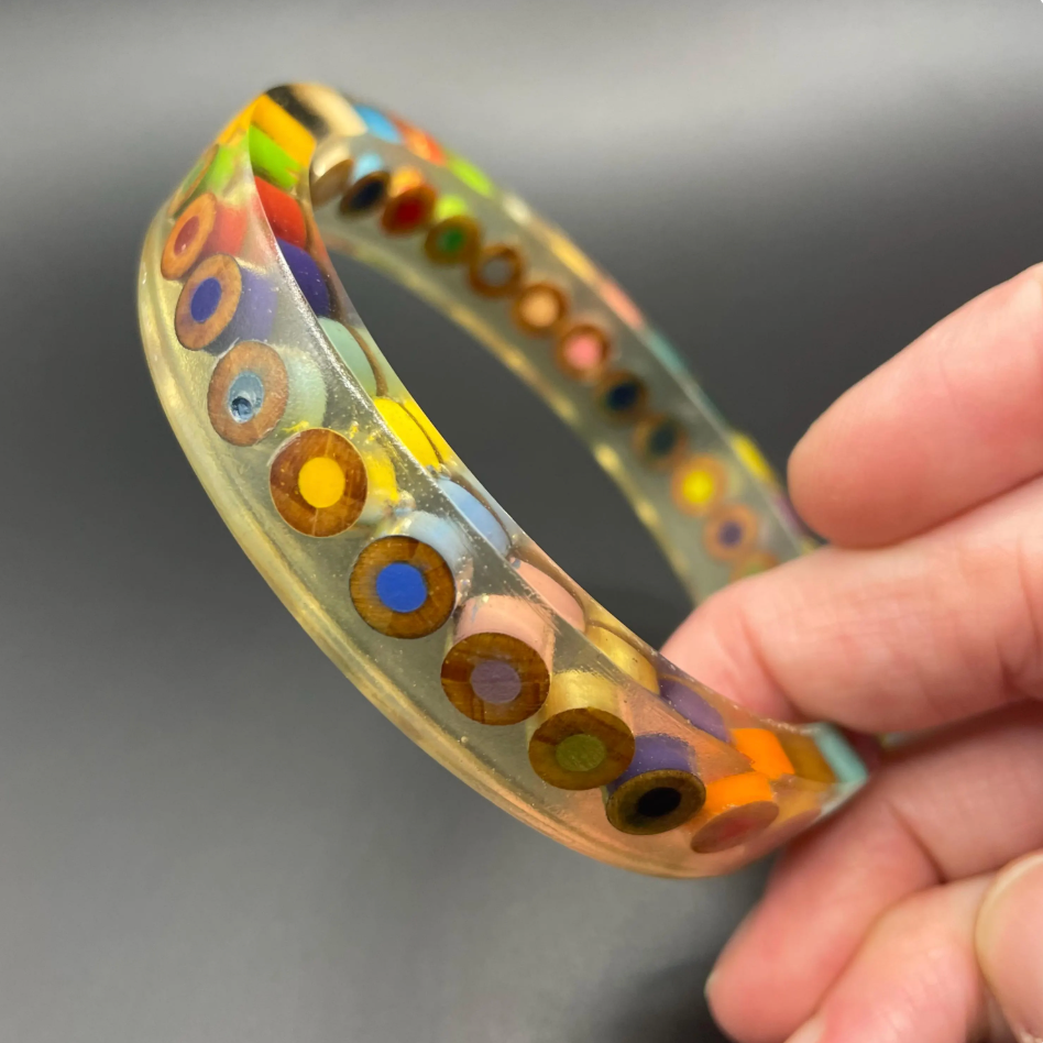 Vintage clear /apple juice tinted plastic / resin inclusion bangle enclosing slices of colouring pencils, multicoloured, handmade