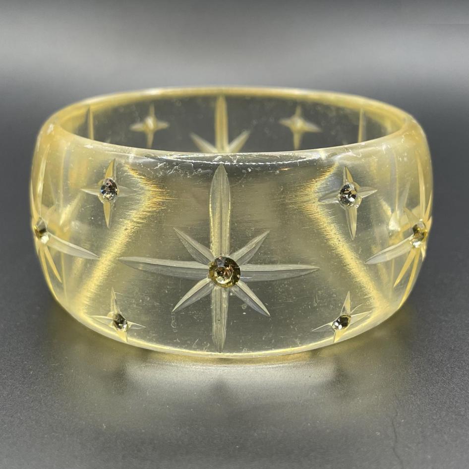 Vintage apple juice coloured transparent plastic wide, engraved bangle, studded with clear glass rhinestones, Art Deco style