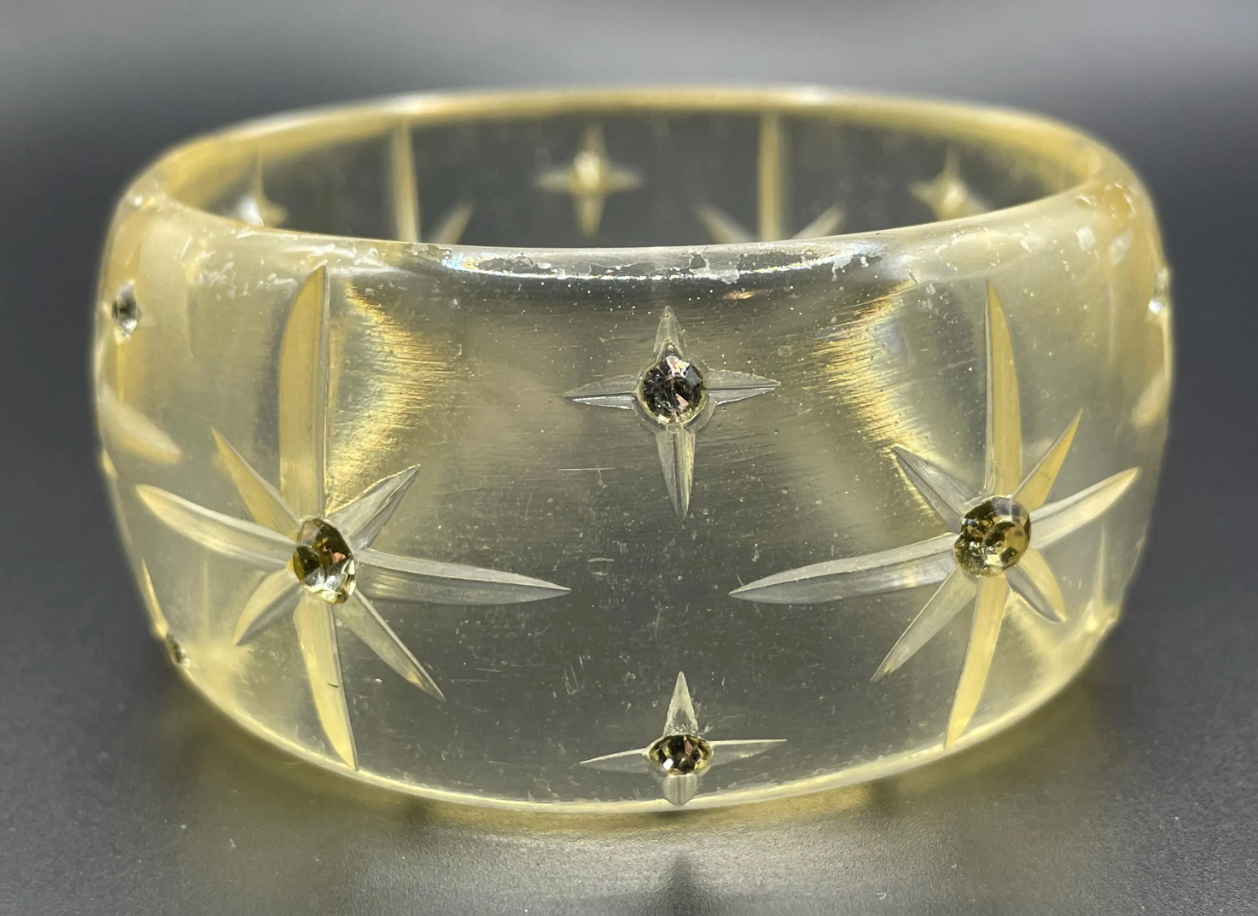 Vintage apple juice coloured transparent plastic wide, engraved bangle, studded with clear glass rhinestones, Art Deco style