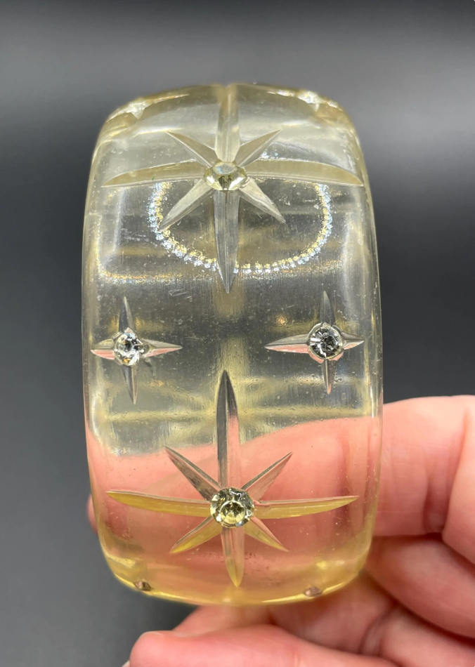 Vintage apple juice coloured transparent plastic wide, engraved bangle, studded with clear glass rhinestones, Art Deco style