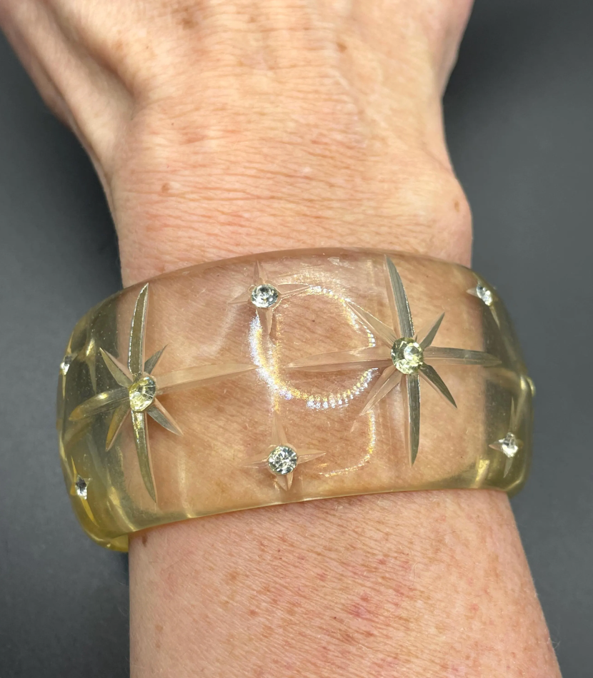 Vintage apple juice coloured transparent plastic wide, engraved bangle, studded with clear glass rhinestones, Art Deco style