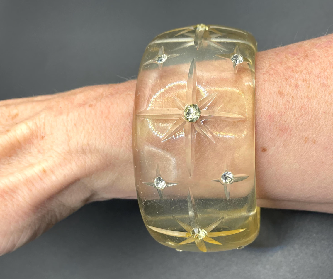 Vintage apple juice coloured transparent plastic wide, engraved bangle, studded with clear glass rhinestones, Art Deco style