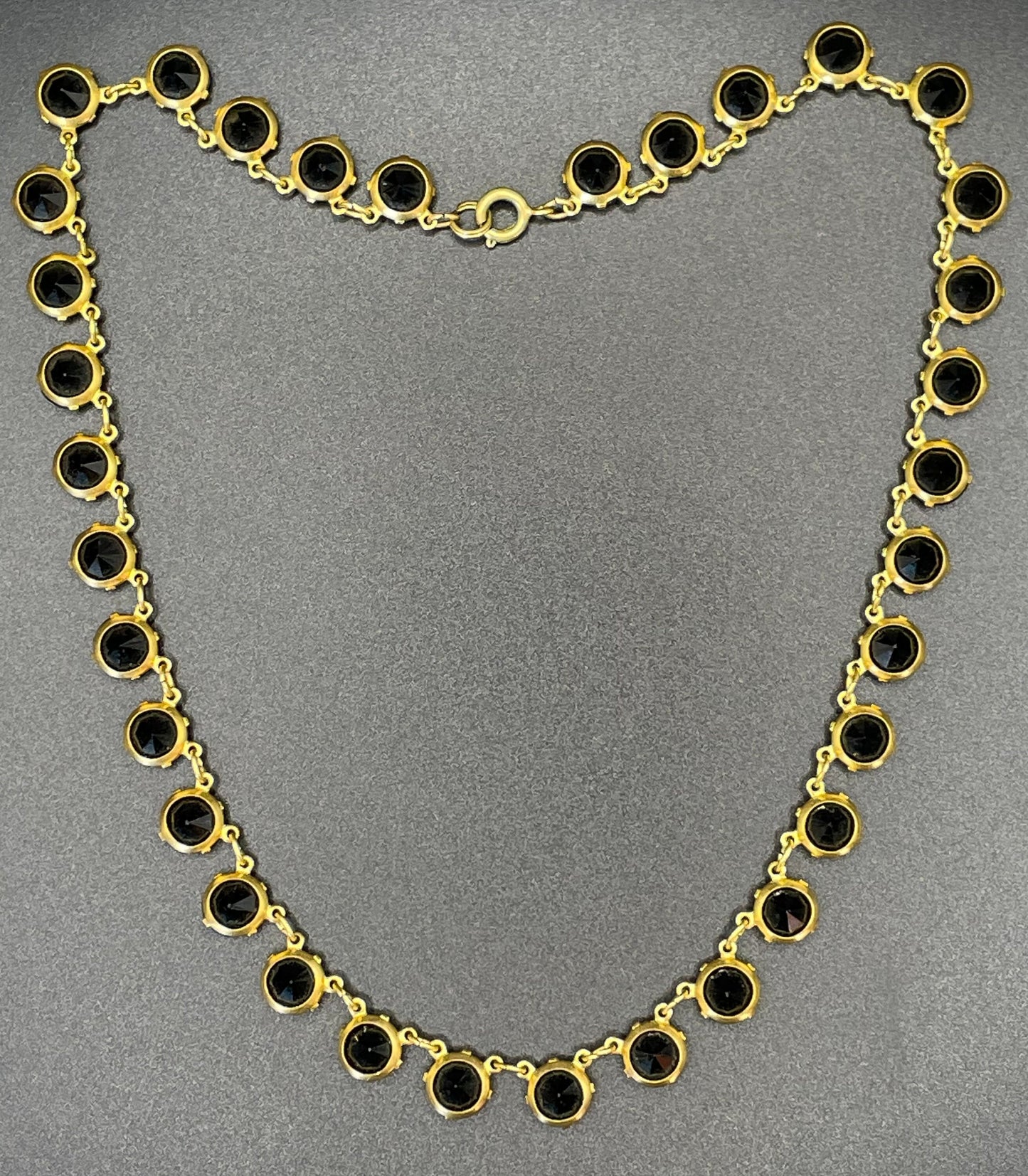 Vintage Art Deco black French jet crystal riviere necklace, single strand, bezel set, open backed rhinestones in gold tone