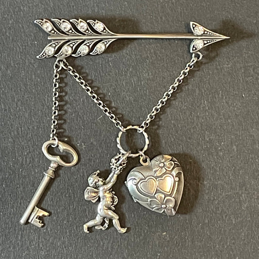 Large early Askew London, vintage cupid's arrow love brooch in antique silver tone with rhinestones, cherub, heart locket and key