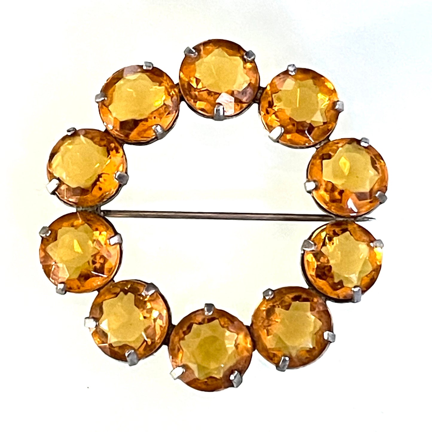 Vintage Art Deco bezel set sunshine coloured citrine yellow / orange crystal riviere circle brooch, open-backed rhinestones in silver tone