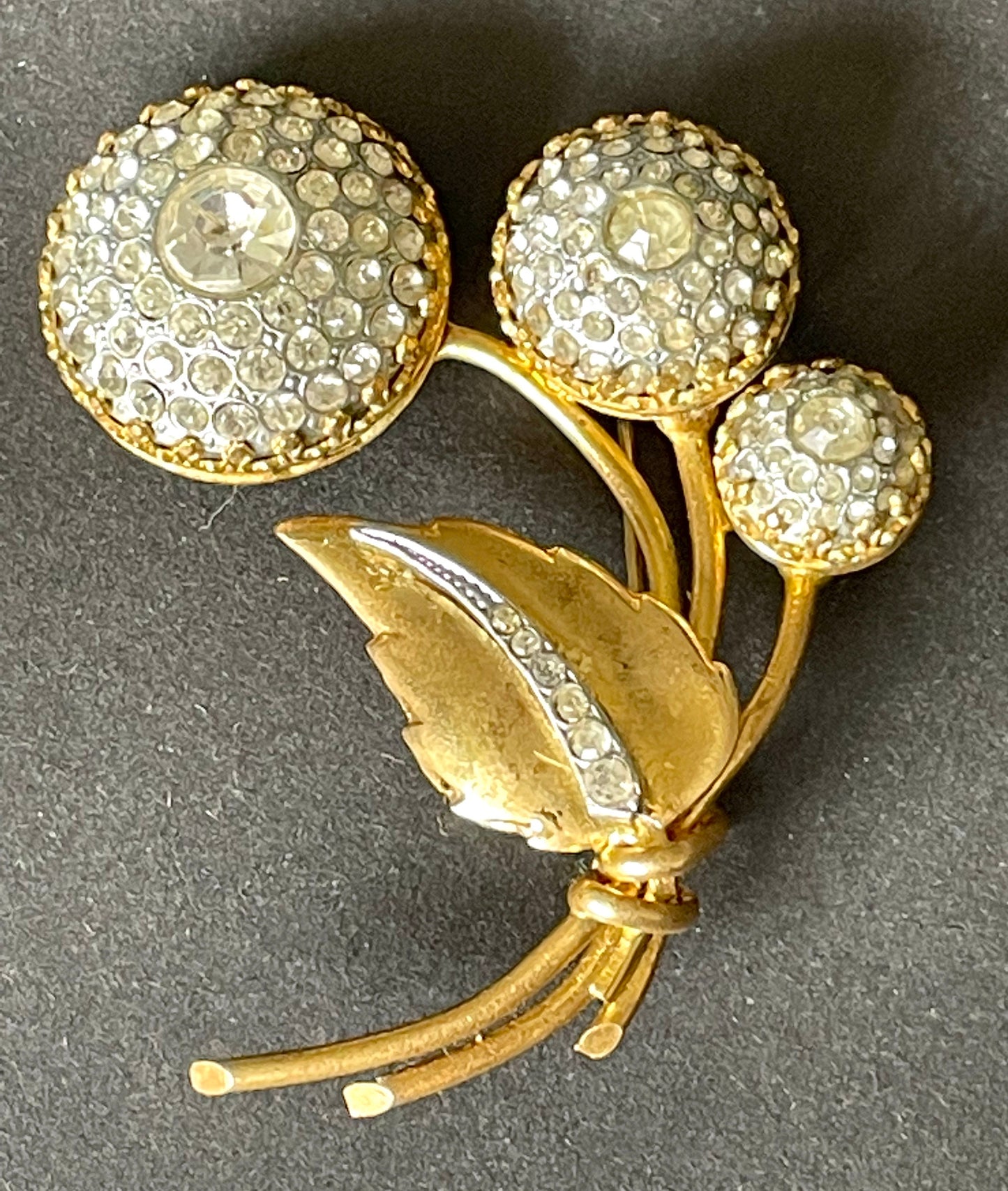 Large vintage Art Deco clear paste and gold tone floral brooch with unusual claw set rhinestone encrusted circular pieces