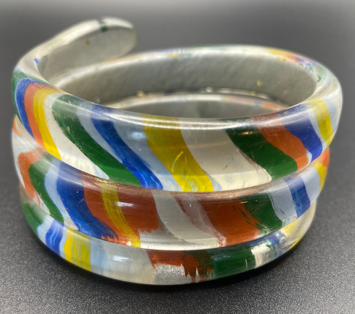 Vintage Art Deco 1920s to 1930s rainbow painted, clear celluloid spiral snake bangle bracelet, blue rhinestone eyes