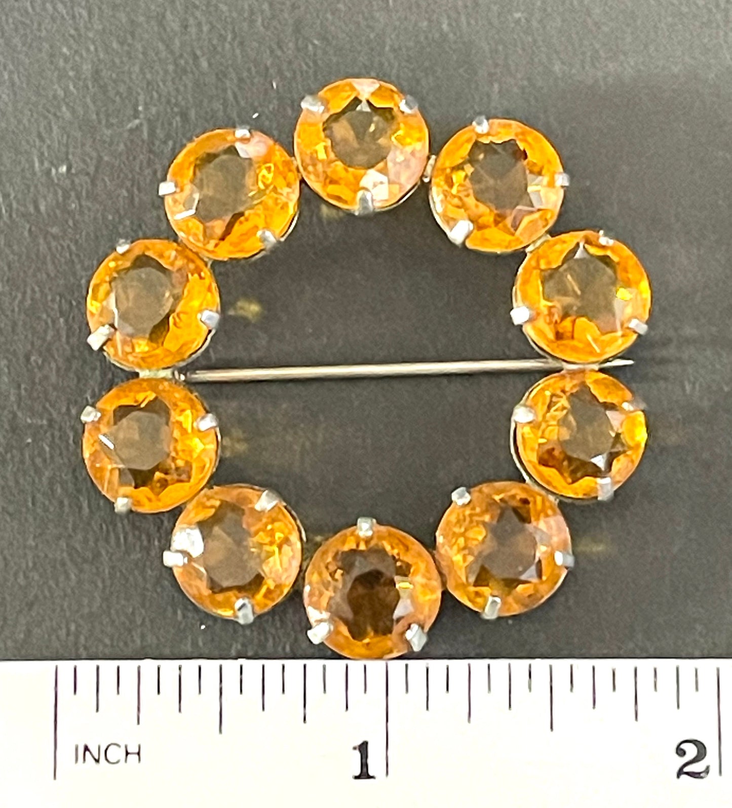 Vintage Art Deco bezel set sunshine coloured citrine yellow / orange crystal riviere circle brooch, open-backed rhinestones in silver tone