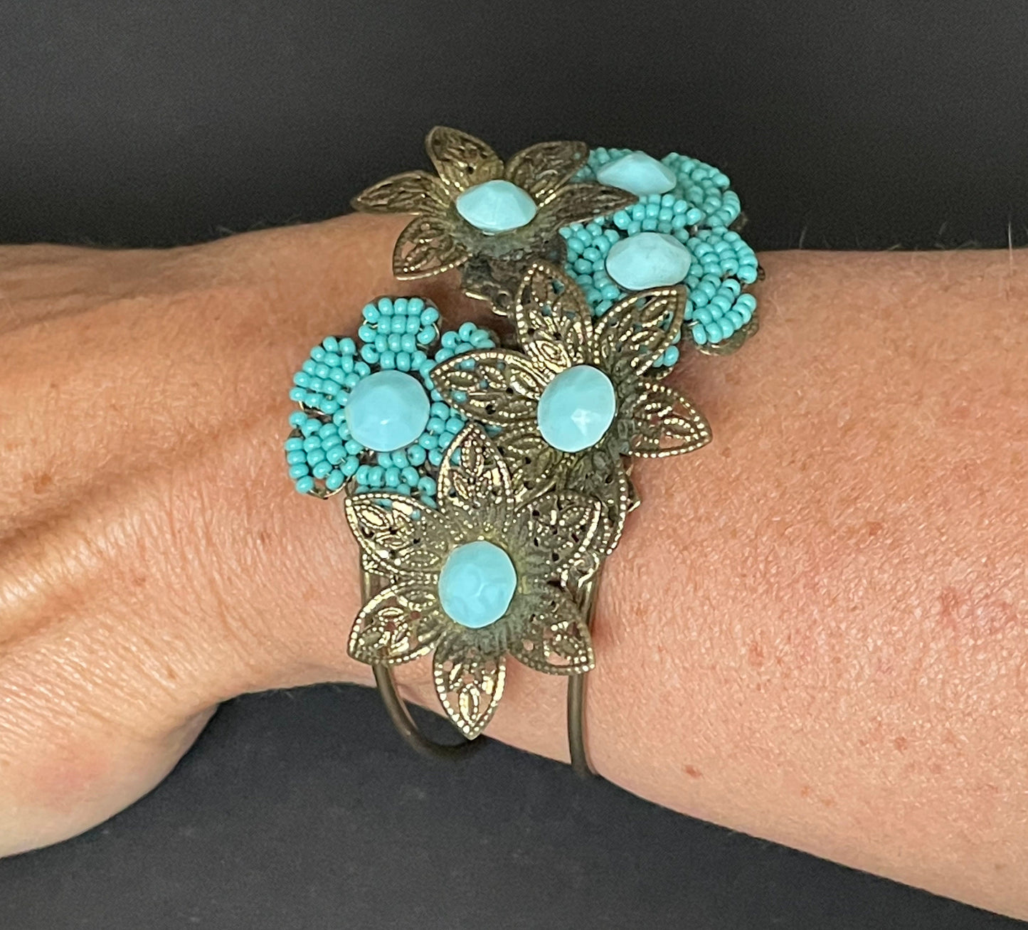 Vintage early Miriam Haskell turquoise blue glass beaded floral clamper bangle with intricate micro beading and gold tone filigree