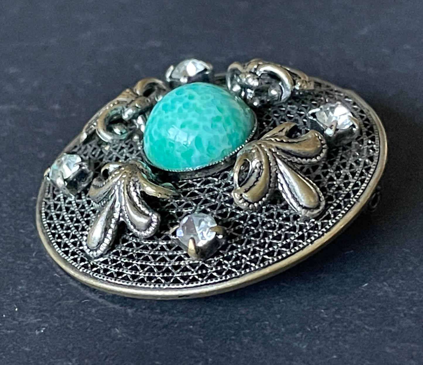 Vintage Czech or Chinese export style Art Deco green Peking glass cabochon and clear rhinestone brooch in silver tone filigree