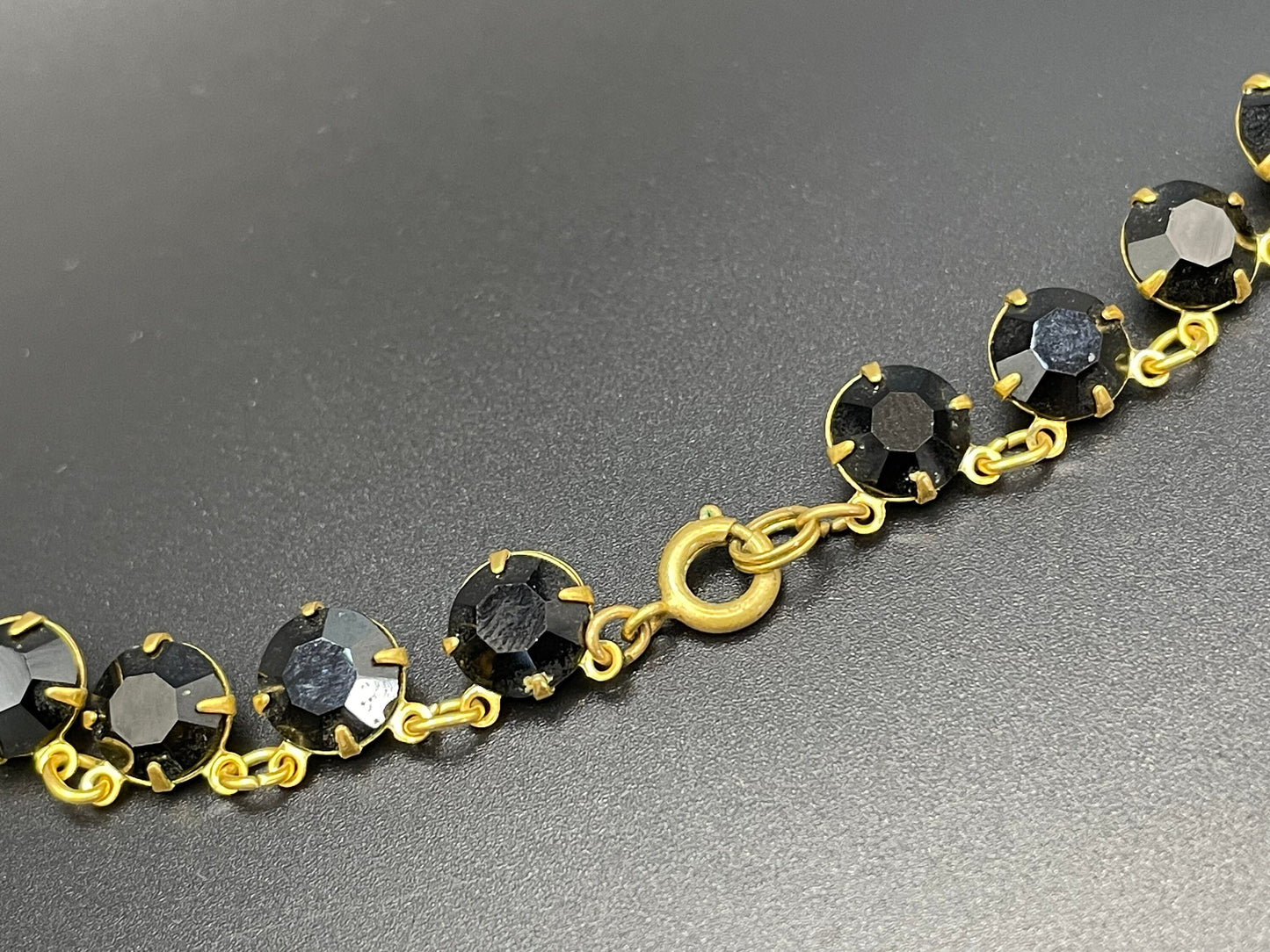 Vintage Art Deco black French jet crystal riviere necklace, single strand, bezel set, open backed rhinestones in gold tone