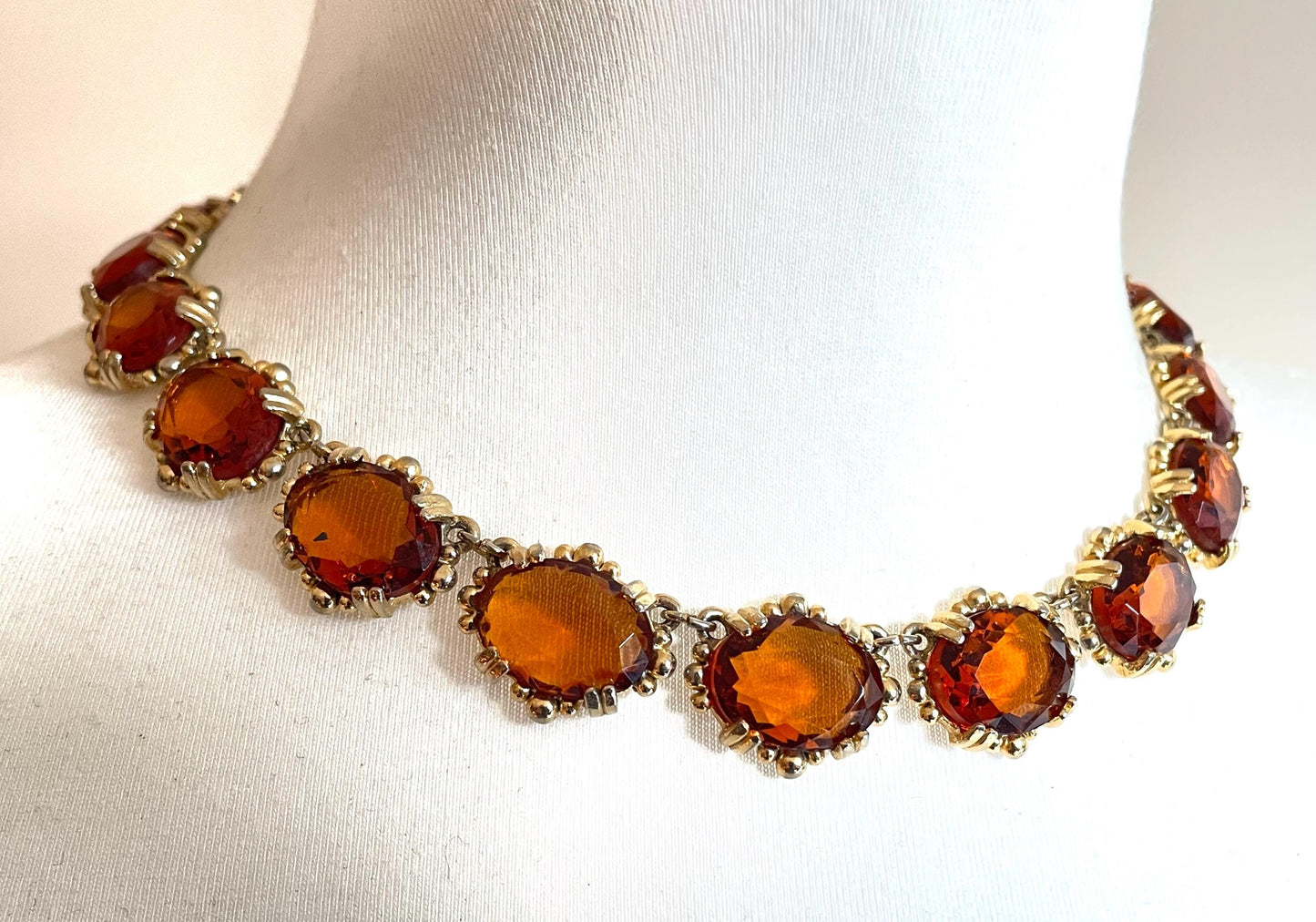 Vintage bright orange topaz / citrine yellow riviere necklace, made by Sphinx, bezel set, open-backed stones in ornate gold tone setting