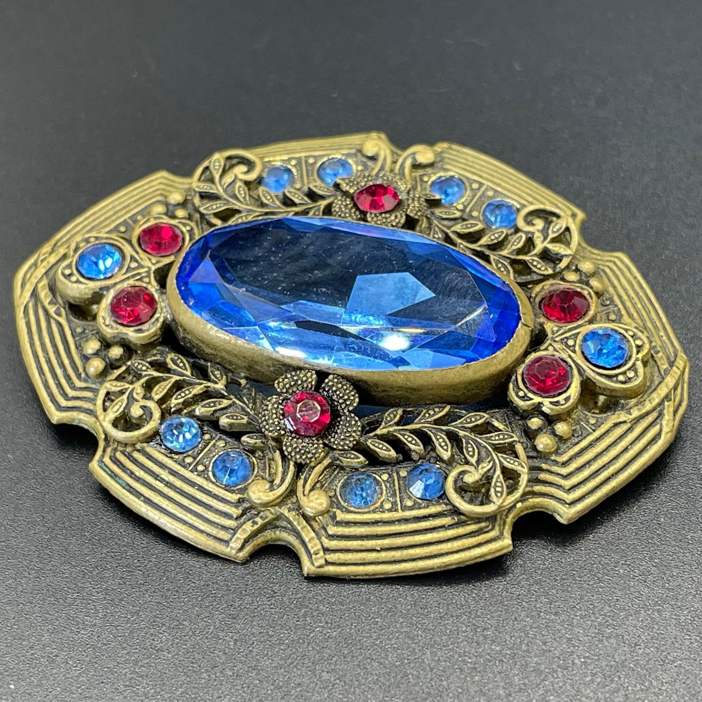 Large vintage Art Deco sapphire blue and bright ruby red rhinestone and ornate gold tone floral design Czech brooch, Neiger style