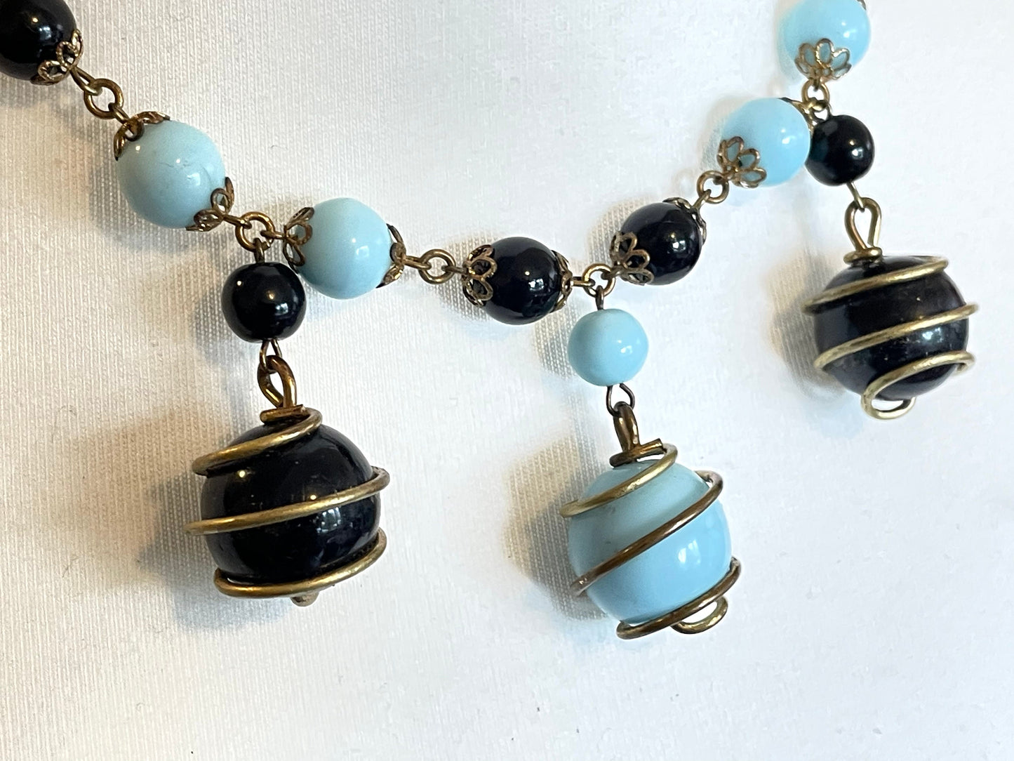 Vintage black and pale blue glass berry beaded charm necklace, gold tone wire spiral cages and filigree bead caps