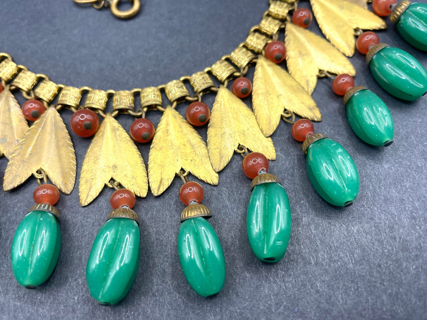 Vintage early Miriam Haskell jade green and orange poured glass beaded and gold tone Egyptian revival fringe necklace with book chain links