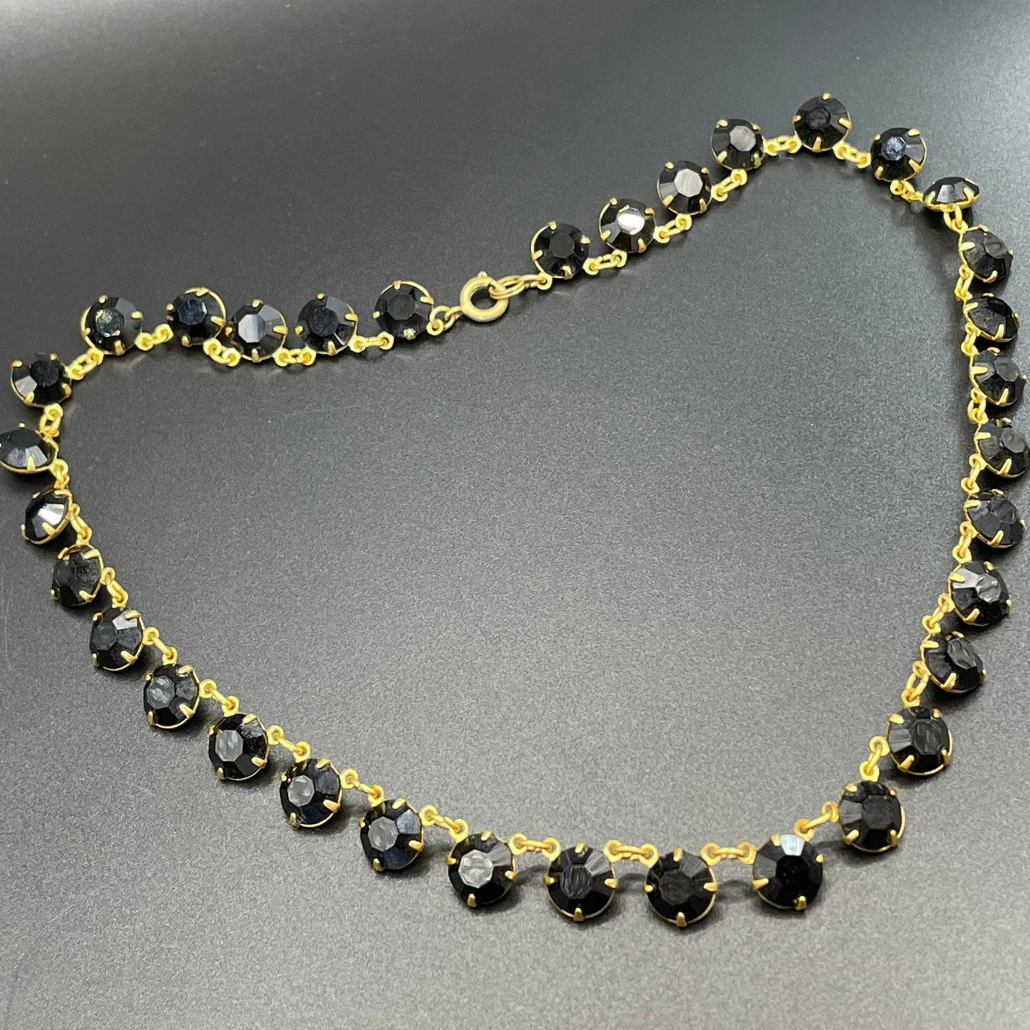 Vintage Art Deco black French jet crystal riviere necklace, single strand, bezel set, open backed rhinestones in gold tone