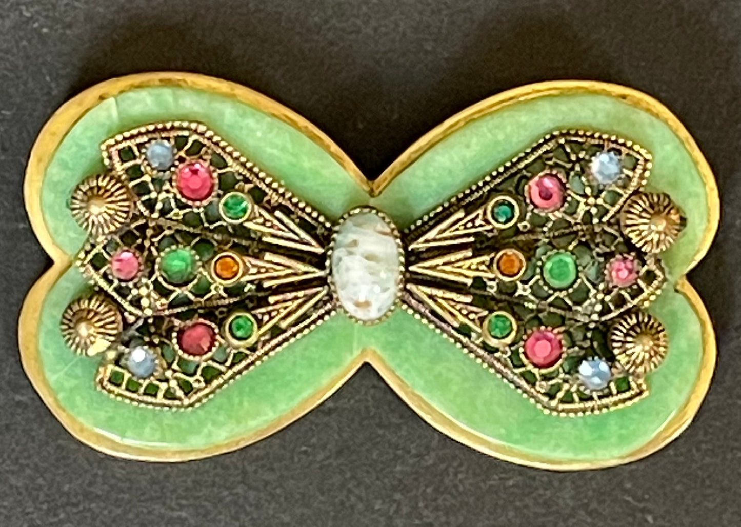 Vintage Art Deco bow shaped brooch, green galalith, gold tone with filigree and multi-coloured rhinestones Max Neiger brothers style