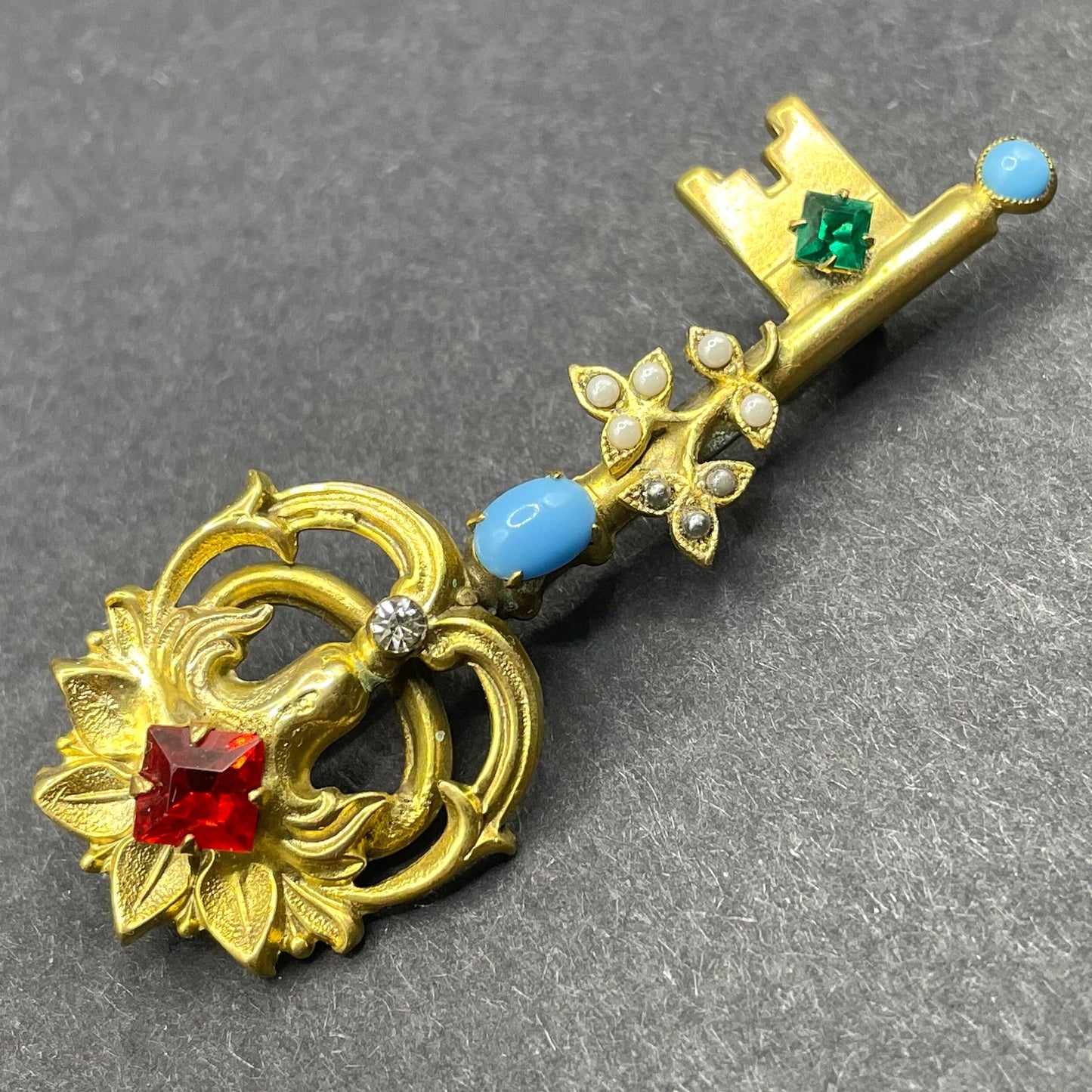 Vintage key brooch, gold tone, white and black glass pearls, red and green rhinestones and turquoise glass cabochons, old presentation box