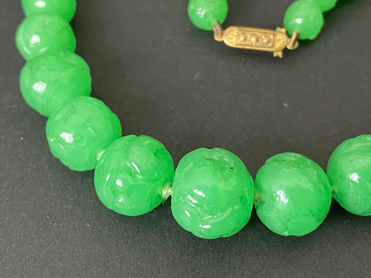 Vintage bright green jade coloured moulded glass graduated bead necklace, hand-knotted with gold tone fish hook clasp