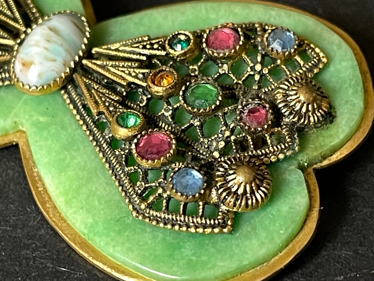 Vintage Art Deco bow shaped brooch, green galalith, gold tone with filigree and multi-coloured rhinestones Max Neiger brothers style