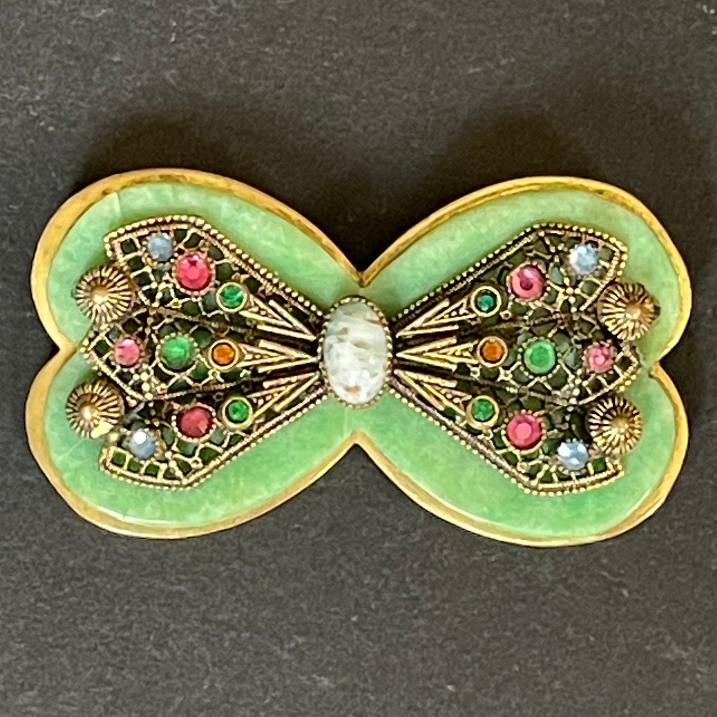 Vintage Art Deco bow shaped brooch, green galalith, gold tone with filigree and multi-coloured rhinestones Max Neiger brothers style