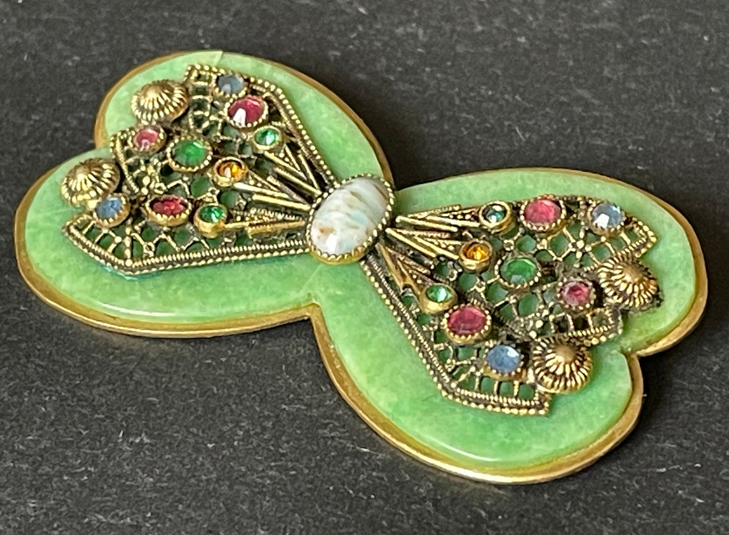 Vintage Art Deco bow shaped brooch, green galalith, gold tone with filigree and multi-coloured rhinestones Max Neiger brothers style